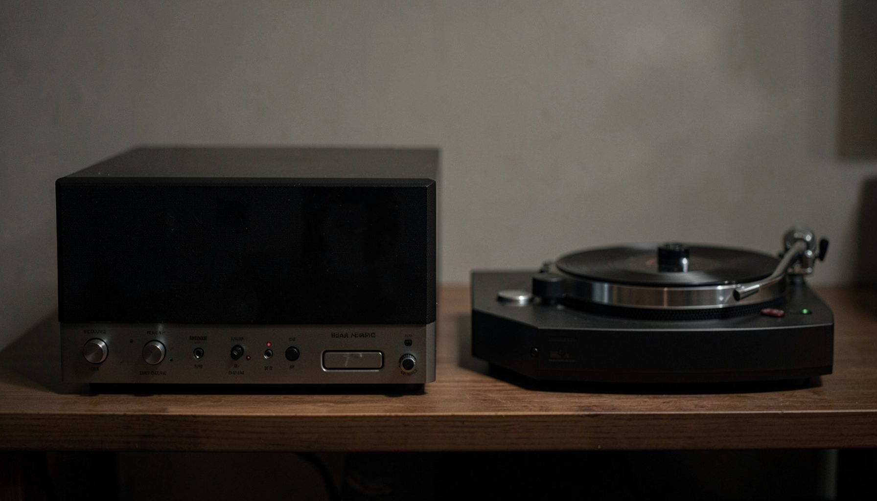 A rack of audio electronics including a substantial amplifier with a dark faceplate, a compact DAC, and a turntable with a sleek tonearm, arranged on a low wooden shelf in subdued lighting.